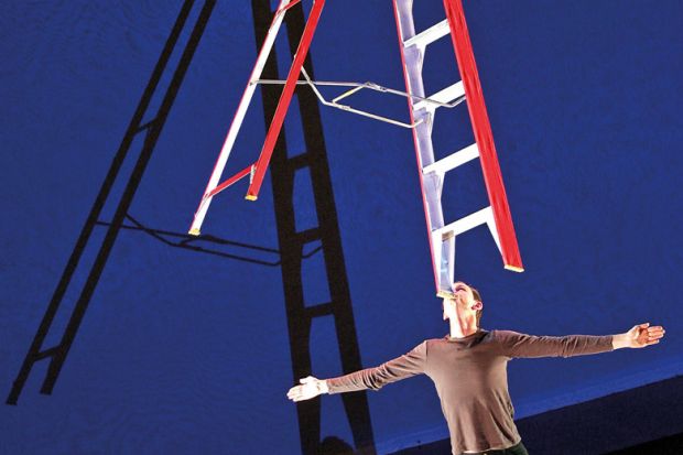A performer balances a giant ladder on his chin A performer balances a giant ladder on his chin to illustrate Career advancement policies ‘used for wage theft’