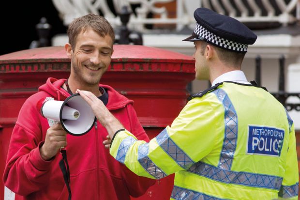 A police officer remonstrates with a protester on a street during a demonstration in London to illustrate Legal action will be a ‘last resort’ as campus free speech bill redrawn