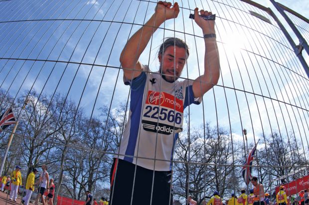 An exhausted competitor attempts to recover after crossing the finish line to illustrate Administrator burnout risks ‘destabilising’ universities