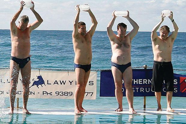 People carry ice blocks as they prepare to get into the pool next to the Pacific Ocean at Bondi Beach in Sydney.
