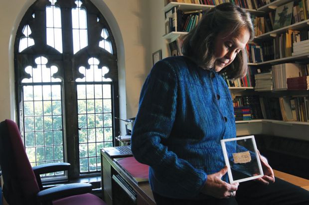 Deceptive text: Karen King with the fragment said to be the Gospel of Jesus’s Wife.The papyrus, now acknowledged as a fabrication