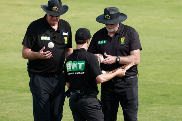 The umpires choose another ball at Lavington Sports Ground, Australia The umpires choose another ball at Lavington Sports Ground, Australia to illustrate Don’t pick sides in superpower rivalry, universities warned