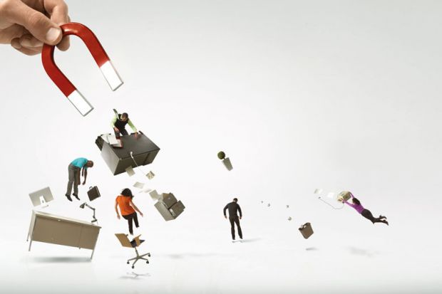 Giant hand and magnet picking up office and workers Giant hand and magnet picking up office and workers to illustrate labour pains