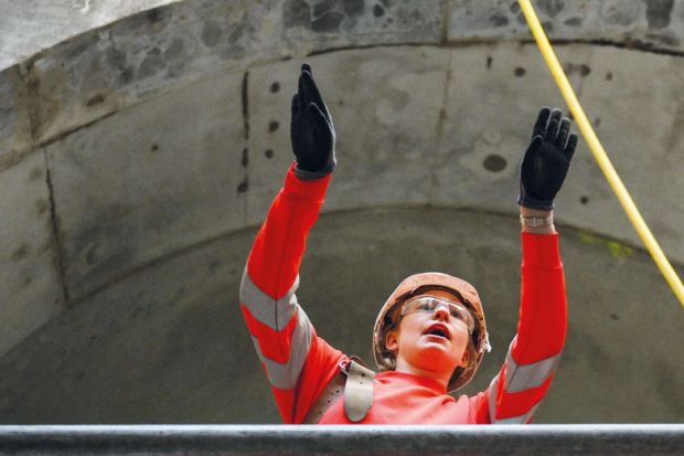 Civil engineer working on a wide concrete tunnel to illustrate Raac closures and disruption ‘worst case scenario’ as term begins