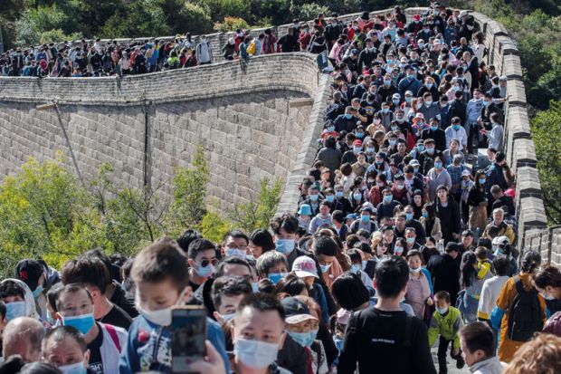 People crowd in a bottleneck as they move slowly on a section of the Great Wall at Badaling People crowd in a bottleneck as they move slowly on a section of the Great Wall at Badaling to illustrate Overseas students struggle to get documents to return to China