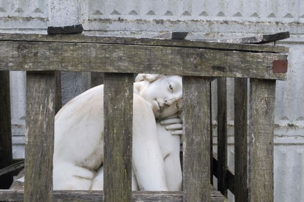Marble female statue caged in a wooden crate Marble female statue caged in a wooden crate to illustrate Scholars are wounded in academia’s gender wars