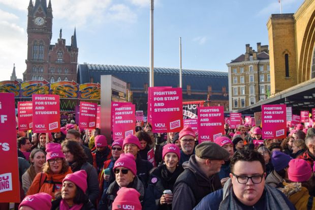 Protesters hold UCU strike placards during a rally to illustrate Pay must be sustainable for institutions rich and poor, v-cs say