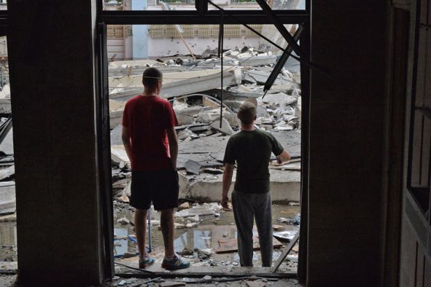 Workers inspect the damage after a Russian missile hits the National Technical University in Kharkiv, Ukraine  Workers inspect the damage after a Russian missile hits the National Technical University in Kharkiv, Ukraine to illustrate Ukrainian staff report high anxiety and little institutional help