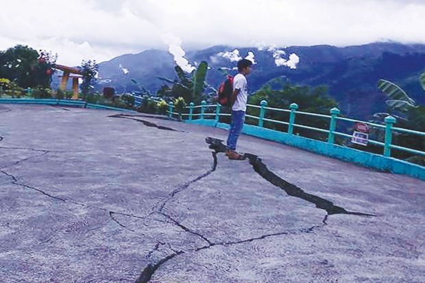 Person stands next to cracks in the ground at a park in Leyte province, central Philippines Person stands next to cracks in the ground at a park in Leyte province, central Philippines as a metaphor for the pan-regional university risks being split by the same tensions