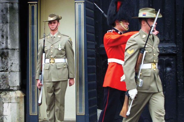 An Australia's Federation Guard mans the sentry box with two other guards marching away.jpg A member of Australia's Federation Guard mans the sentry box with two other guards marching away, one also an Australia's Federation Guard the other a British Grenadier Guard, as a metaphor for Australian institutions changing guard.