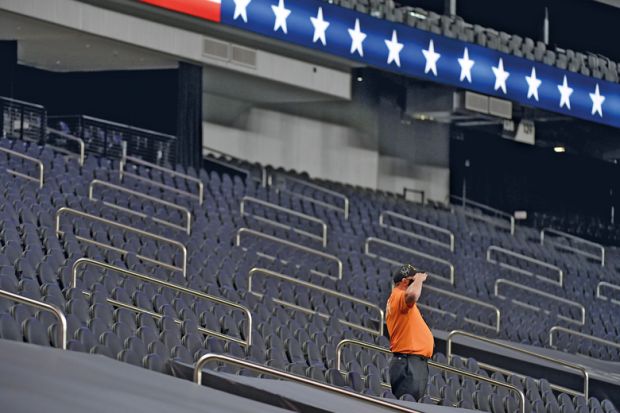 A security guard salutes while standing among empty seatsin Las Vegas, Nevada A security guard salutes while standing among empty seatsin Las Vegas, Nevada to illustrate US universities fear ‘ghosting’ by international students