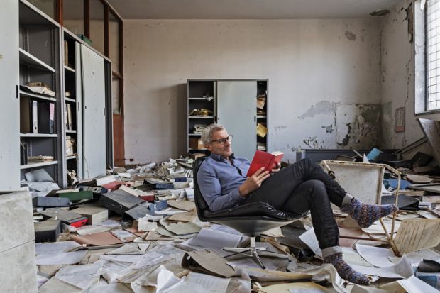 Montage of a person sitting reading in an Abandoned office with many papers on the floor Montage of a person sitting reading in an Abandoned office with many papers on the floor