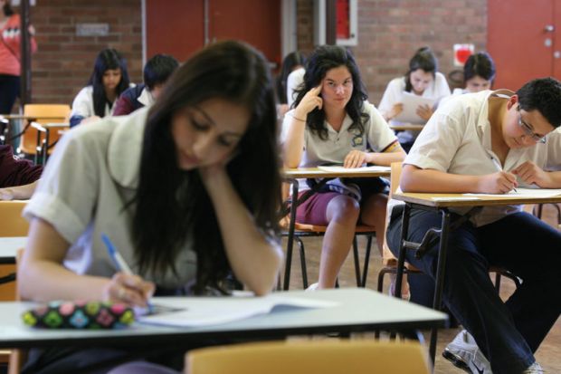Students taking exams to illustrate Australian universities stick with ‘unfair’ early entry schemes