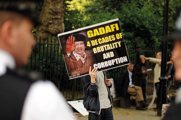 Protesters opposed to Libyan leader Moamer Kadhafi demonstrate outside of the London School of Economics Protesters opposed to Libyan leader Moamer Kadhafi demonstrate outside of the London School of Economics to illustrate English sector ‘won’t be open on foreign donations unless forced’