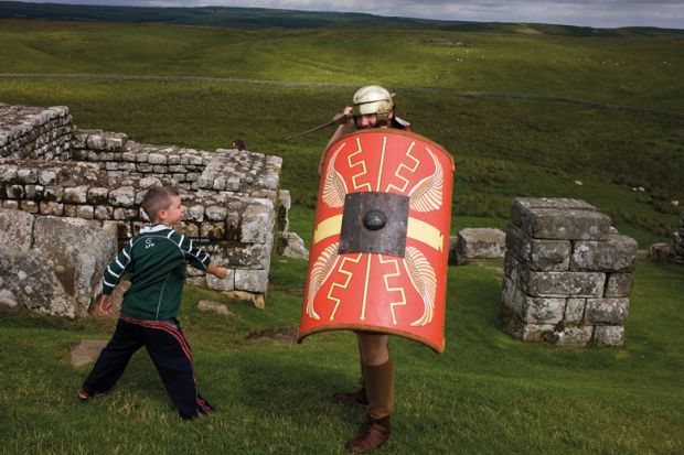 Re-enactment soldier at Housesteads Fort on Roman Hadrian's Wall, to illustrate Universities shun school mentoring ‘to guard global reputation’