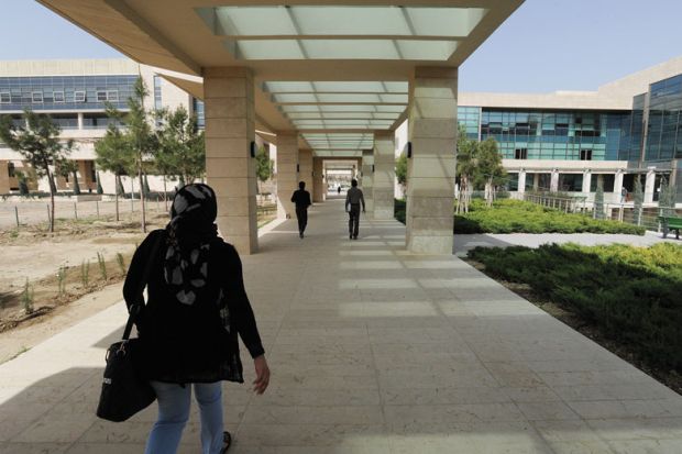 Student walks through campus during her fourth year on scholarship at the American University of Iraq to illustrate Afghan students ‘in doldrums’ at Iraqi university
