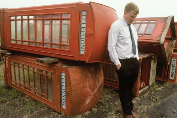 Person with  with old phone boxes for sale