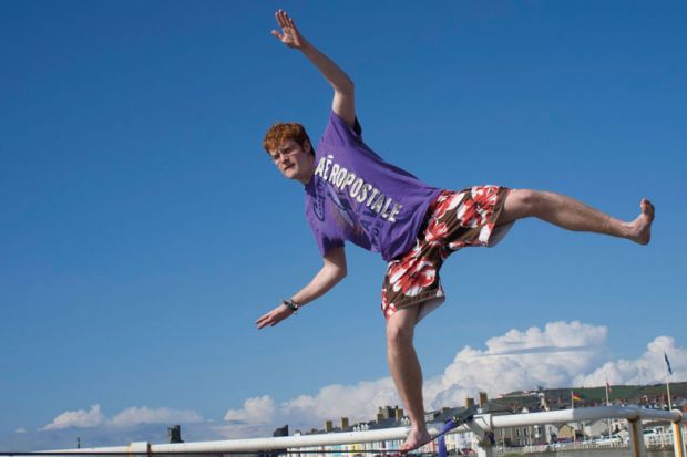 A university college student, on a slack rope balancing to illustrate Business model will ‘soon fail’