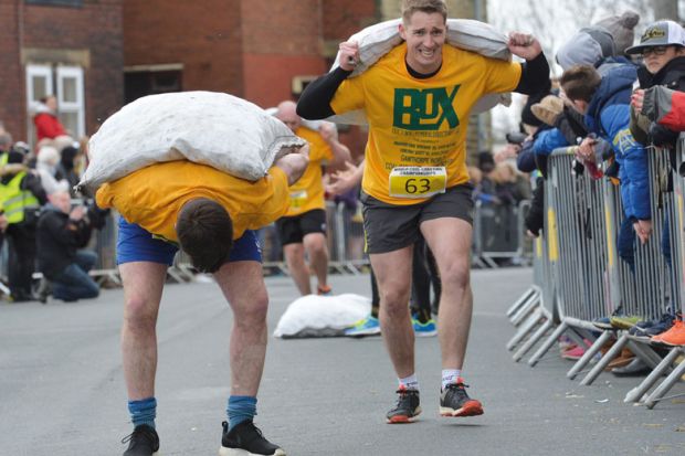 Competitors take part in the World Coal Carrying Championships in Gawthorpe, West Yorkshire. Competitors take part in the World Coal Carrying Championships in Gawthorpe, West Yorkshire to illustrate Staff and students bowed by workloads
