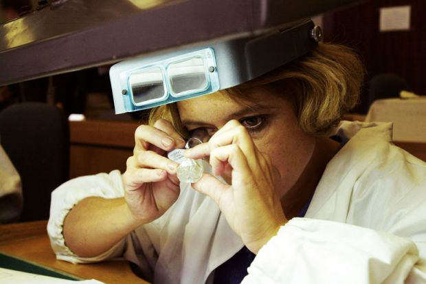  A sorter inspects a 143-carat Russian diamond for France to back not-for-profit diamond journals