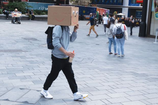A man walks with a cardboard box on his head A man walks with a cardboard box on his head as a metaphor for In journal of taboo topics, anonymity is most daring