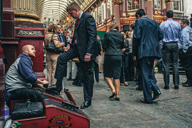 Shoe cleaner is polishing the shoes of a buissnesman in Leadenhall Market Shoe cleaner is polishing the shoes of a buissnesman in Leadenhall Market to illustrate Academics ‘treat staff like scum’