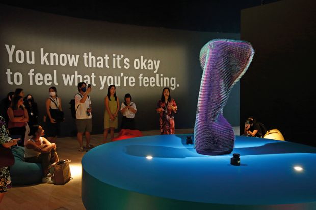 Visitors look at the installation aclled Doing Nothing With AI (2019) by Emanuel Gollob during a media preview to illustrate Cautious experiment with AI in student counselling gets under way