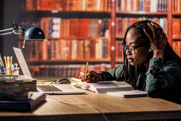 Young woman sitting at table in a library to illustrate My international students make me feel like an academic again