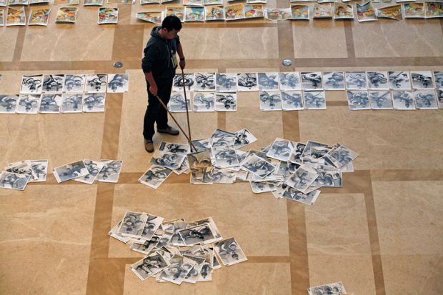 Student's exam papers being swept up from the floor Student's exam papers being swept up from the floor to illustrate China journal crackdown ‘a band-aid rather than a cure’