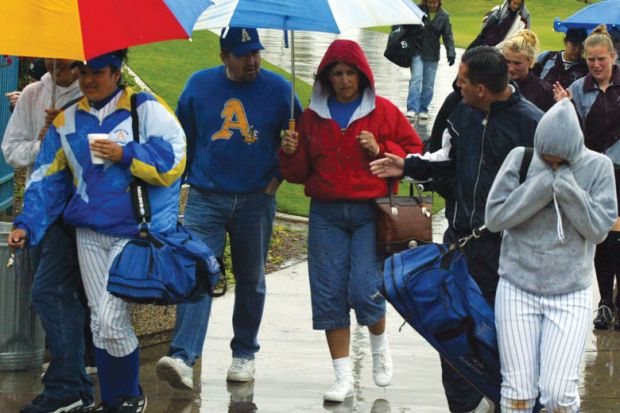 Spectators exit the Woodbridge Softball Classic Tournament which was postponed. Spectators exit the Woodbridge Softball Classic Tournament which was postponed.