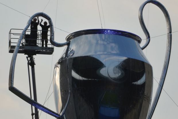 Men working on a giant inflatable trophy.