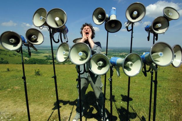 Composer and director of The Shout choir surrounded by megaphones on Devils Dyke, Sussex to illustrate Student complaints hit new record levels in England and Wales