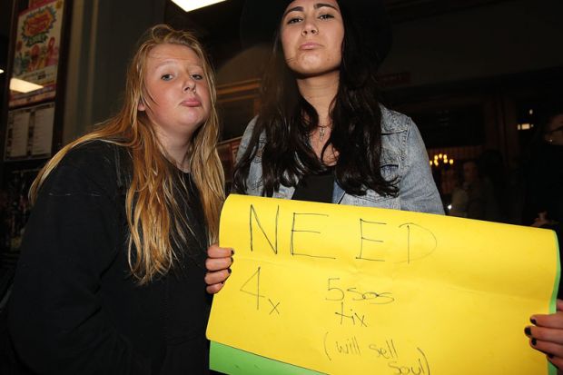 Young fans try to buy tickets for the sold out show to illustrate Australia wrestles with shortage of placements for students
