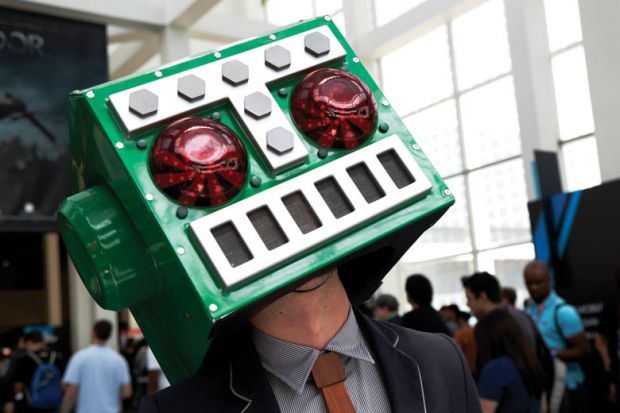   A man in a Destructoid costume on his head as Stanford students sour on big tech careers amid ethics concerns