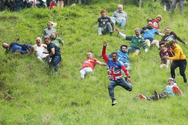 People taking part in the Cheese-Rolling downhill race in Gloucester, England People taking part in the Cheese-Rolling downhill race in Gloucester, England to illustrate Entry rate fall creates ‘strategic uncertainty’ in English sector