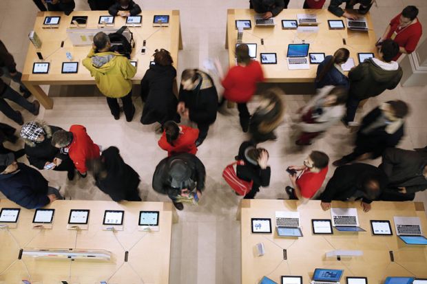 tables with laptops and people
