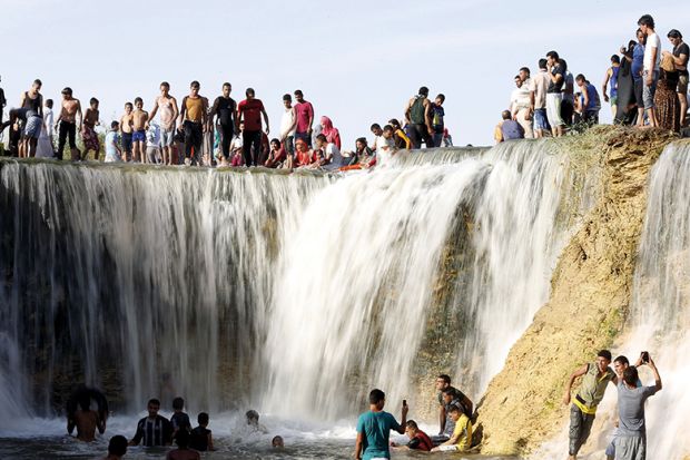 Egyptians enjoy a waterfall in Wadi El-Rayan Egyptians enjoy a waterfall in Wadi El-Rayan