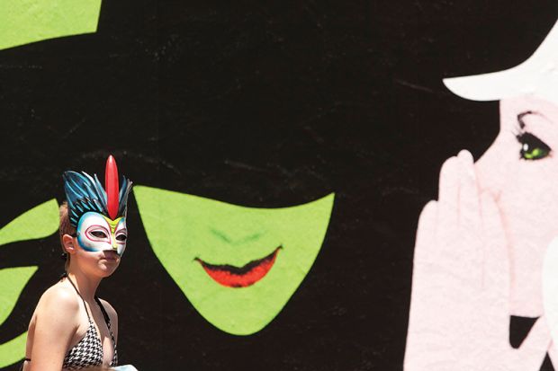 Woman passes Wicked billboard