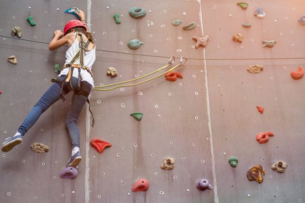 Woman representing a PhD student climbing in an indoor climbing centre Woman representing a PhD student climbing in an indoor climbing centre