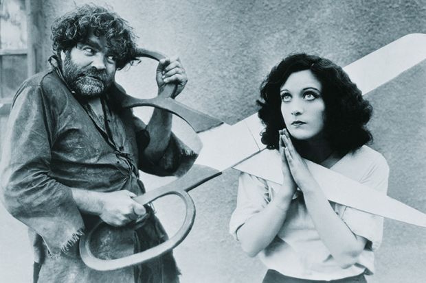 Woman with giant scissors round her neck