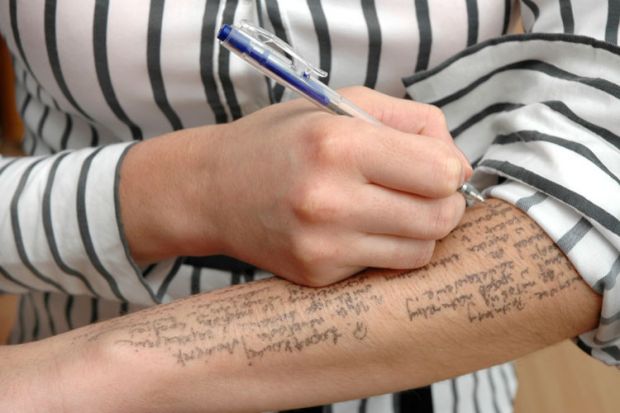 Exam cheating, woman writing notes on arm Exam cheating, woman writing notes on arm