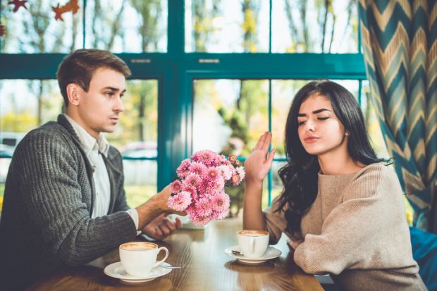 woman rejects flowers from man