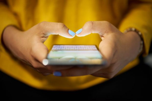 Woman typing on smartphone