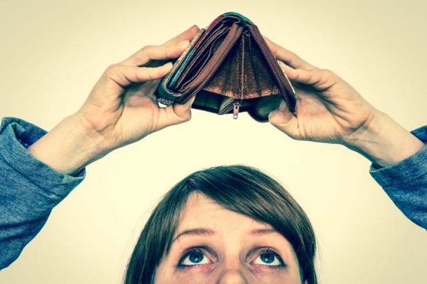 Women looking at empty wallet