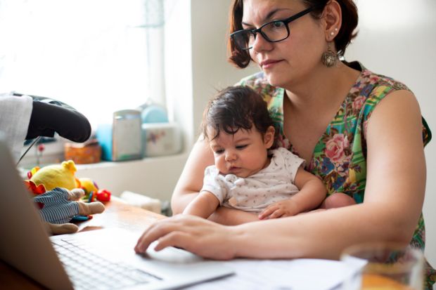 Working mum with baby in lap