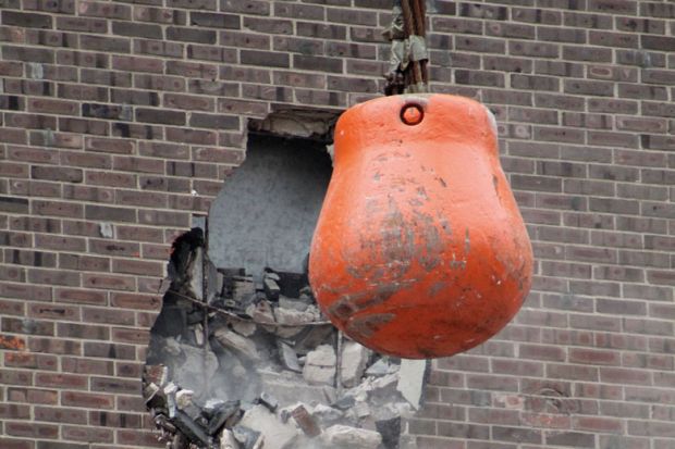 Wrecking ball demolishing wall Wrecking ball demolishing wall