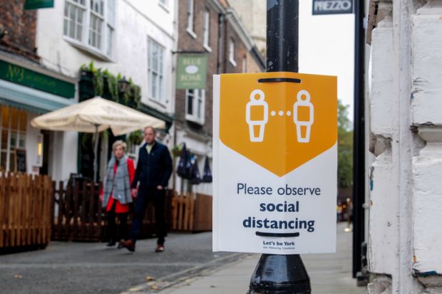 York, UK, England, 24-10-2020, Advisory sign on lamp post in the city Centre advising people observe the social distancing guidelines