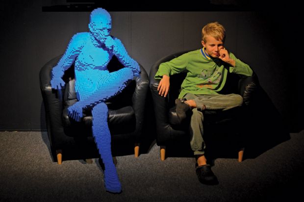 Young boy imitating Lego sculpture Young boy imitating Lego sculpture