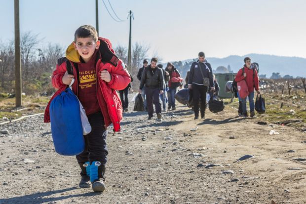 Young boy leads caravan of Syrian refugees Young boy leads caravan of Syrian refugees