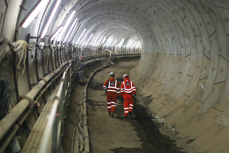 Workers walking through Crossrail tunnel, London Workers walking through Crossrail tunnel, London